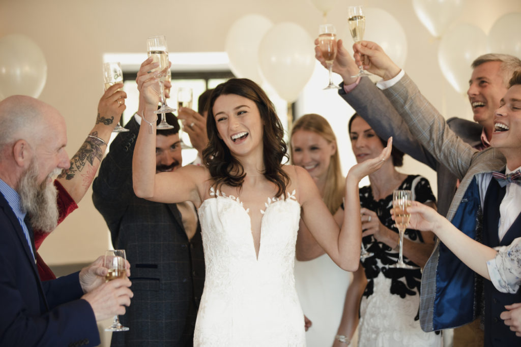 Bride raising her glass for a toast.