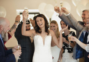 Bride raising her glass for a toast.